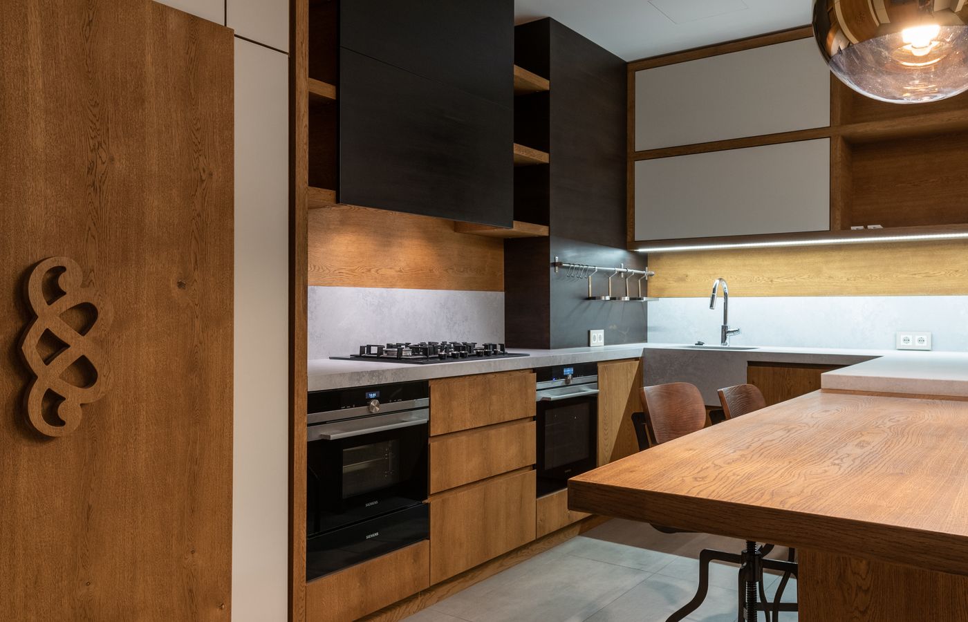 A clean modern kitchen with integrated appliances — Amana repair specialists