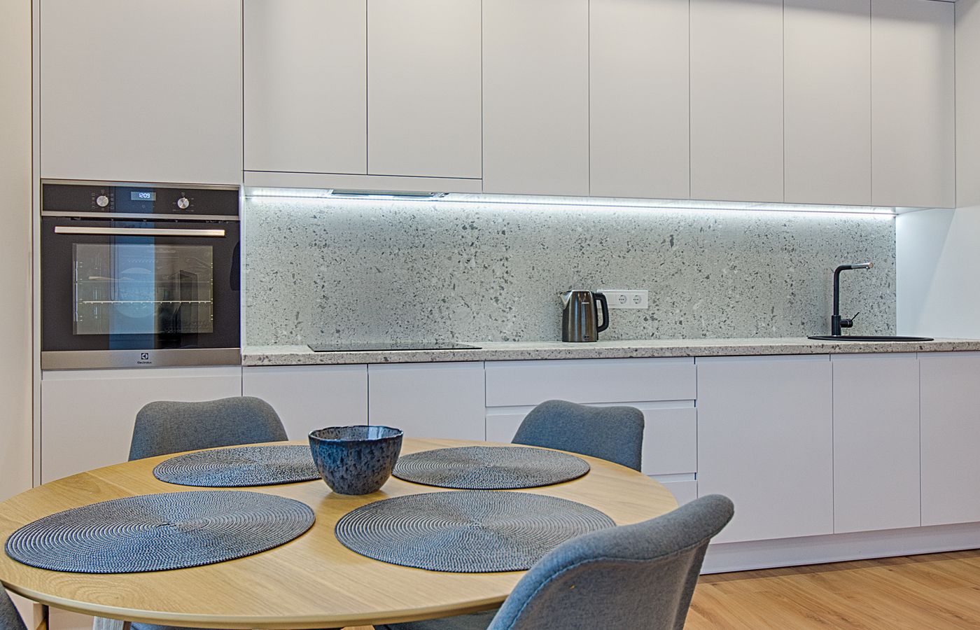 A clean modern kitchen with integrated appliances — Amana repair specialists