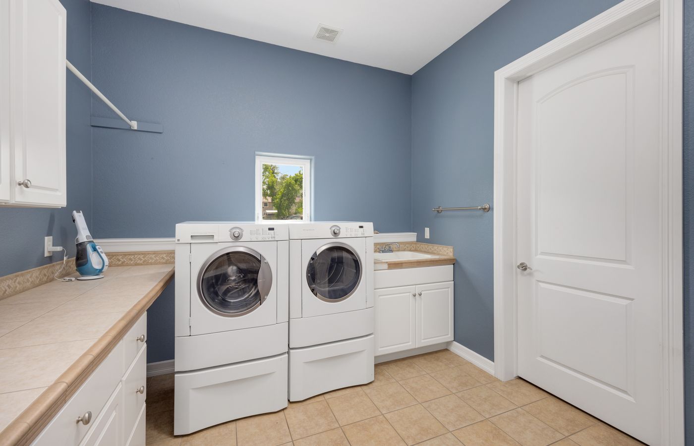 A clean home laundry room with stacked washer and dryer — independent Amana appliance service