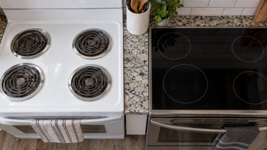 A coil-element range cooktop beside a smooth glass cooktop, seen from above